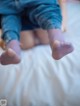 A couple of people sitting on top of a bed.