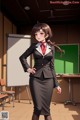 A woman in a school uniform standing in front of a blackboard.