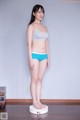 A woman standing on a scale in a room.