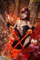 A woman in a black and red outfit holding two swords.